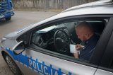 policjant pisze w radiowozie