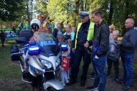 dzieci wraz z policjantem stoją przy policyjnym motocyklu