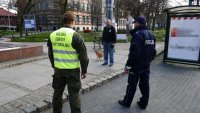 policjant wraz z żołnierzem legitymują osobę