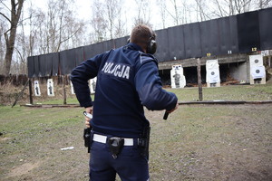 Policjant wyciąga broń