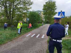 Policjant z uczniami w miasteczku rowerowym