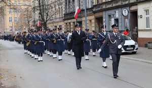 Orkiestra wojskowa maszeruje ulicą.