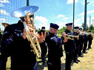 na zdjęciu orkiestra policyjna, mundurowi grają na instrumentach