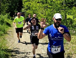na zdjęciu machający uczestnicy, w trakcie biegu