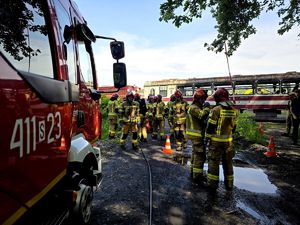 na zdjęciu strażacy obok pociągu czerwonego koloru