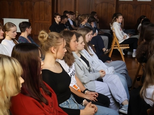 na zdjęciu młodzież siedząca na krzesłach w sali