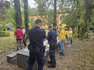 na zdjęciu dwóch policjantów stojących przy uczestnikach