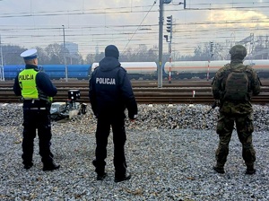 policjant, żołnierz i funkcjonariusz Straży Ochrony Kolei przy torach kolejowych